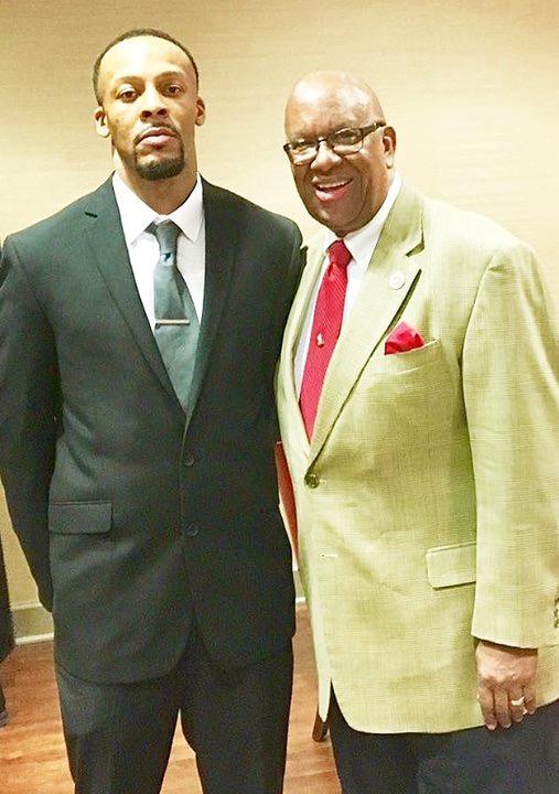 Two men standing together wearing suits