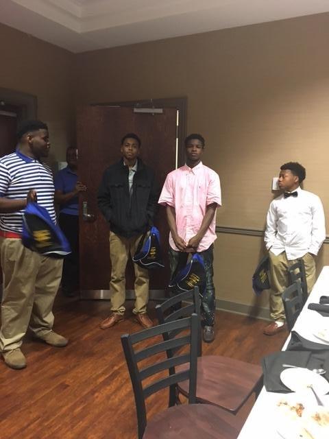 5 young men standing in dress clothes