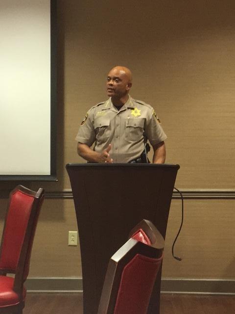 Sheriff speaking at a podium